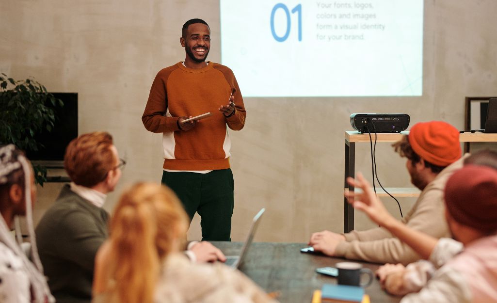 a person giving a presentation to their college class