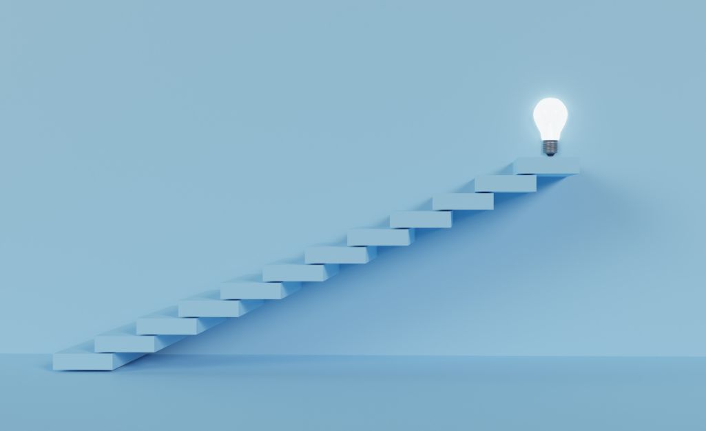 steps leading to a light bulb